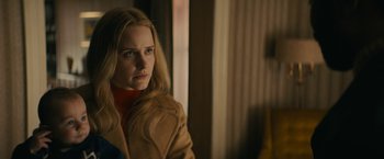 Movie still from “I'm Your Woman” (2020), directed by Julia Hart – A woman in a brown coat looking to her left; Close Up shot, Over the shoulder angle