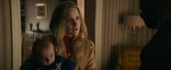 Movie still from “I'm Your Woman” (2020), directed by Julia Hart – A woman holding a baby in her arms; Close Up shot, Over the shoulder angle