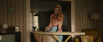 Movie still from “I'm Your Woman” (2020), directed by Julia Hart – A woman is ironing clothes on an ironing board; Medium shot, Low angle