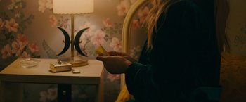 Movie still from “I'm Your Woman” (2020), directed by Julia Hart – A woman holding a piece of paper in her hands; Medium shot, Over the shoulder angle