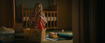 Movie still from “I'm Your Woman” (2020), directed by Julia Hart – A woman and a baby in a room with a crib; Medium shot, High angle