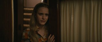 Movie still from “I'm Your Woman” (2020), directed by Julia Hart – A young woman standing in front of a window; Close Up shot, Over the shoulder angle