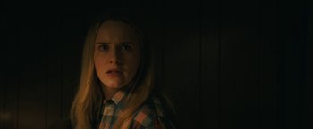 Movie still from “I'm Your Woman” (2020), directed by Julia Hart – A young girl in a plaid shirt looking at the camera; Close Up shot, Over the shoulder angle