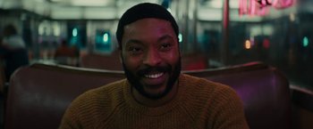 Movie still from “I'm Your Woman” (2020), directed by Julia Hart – A person smiling for a picture; Close Up shot, High angle