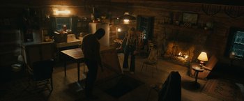 Movie still from “I'm Your Woman” (2020), directed by Julia Hart – Two people standing in a room in a cabin; Wide shot, High angle