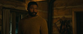 Movie still from “I'm Your Woman” (2020), directed by Julia Hart – A man in a brown sweater is looking at the camera; Medium shot, Over the shoulder angle