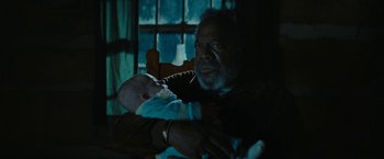 Movie still from “I'm Your Woman” (2020), directed by Julia Hart – An older man holding a baby in his arms; Close Up shot, High angle