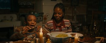 Movie still from “I'm Your Woman” (2020), directed by Julia Hart – Two people sitting at a table with a bowl of food; Medium shot, Over the shoulder angle