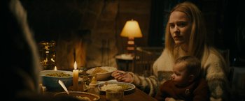 Movie still from “I'm Your Woman” (2020), directed by Julia Hart – A woman sitting at a table with a plate of food in front of her; Medium shot, Over the shoulder angle