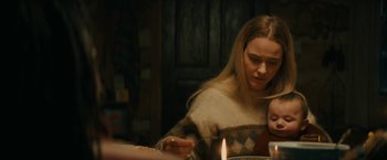 Movie still from “I'm Your Woman” (2020), directed by Julia Hart – A woman sitting at a dinner table with a child; Medium shot, Over the shoulder angle