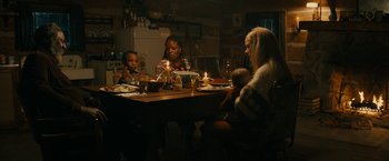 Movie still from “I'm Your Woman” (2020), directed by Julia Hart – A group of people sitting at a table with candles; Medium shot, High angle