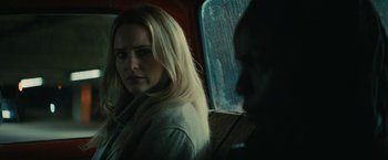 Movie still from “I'm Your Woman” (2020), directed by Julia Hart – A woman sitting on a bus looking at the camera; Close Up shot, Over the shoulder angle