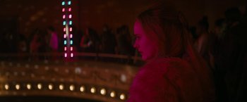 Movie still from “I'm Your Woman” (2020), directed by Julia Hart – A woman wearing a fur coat standing in front of a stage; Medium shot, Over the shoulder angle