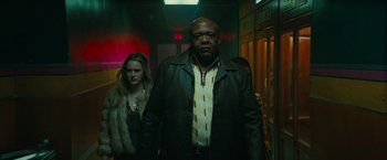 Movie still from “I'm Your Woman” (2020), directed by Julia Hart – A man and a woman are walking down a hallway; Medium shot, Low angle