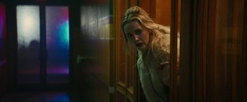 Movie still from “I'm Your Woman” (2020), directed by Julia Hart – A woman in a white fur coat looking at the camera; Close Up shot, Over the shoulder angle