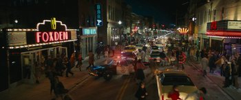 Movie still from “I'm Your Woman” (2020), directed by Julia Hart – A busy city street at night with a lot of traffic; Extreme Wide shot, High angle