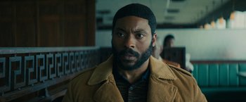 Movie still from “I'm Your Woman” (2020), directed by Julia Hart – A person with a beard wearing a jacket; Close Up shot, Low angle