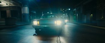Movie still from “I'm Your Woman” (2020), directed by Julia Hart – A car driving down a street at night; Wide shot, Low angle