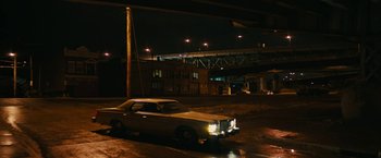 Movie still from “I'm Your Woman” (2020), directed by Julia Hart – A car parked on the side of the road at night; Extreme Wide shot, High angle
