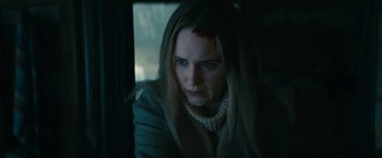 Movie still from “I'm Your Woman” (2020), directed by Julia Hart – A woman with a scar on her face looking out of a window; Close Up shot, Low angle
