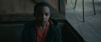 Movie still from “I'm Your Woman” (2020), directed by Julia Hart – A young boy wearing a red shirt and a green jacket; Close Up shot, High angle