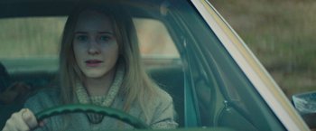 Movie still from “I'm Your Woman” (2020), directed by Julia Hart – A woman sitting in the driver's seat of a car; Close Up shot, Over the shoulder angle