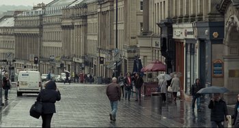 Movie still from “I, Daniel Blake” (2016), directed by Ken Loach – A group of people walking down a street; Extreme Wide shot, High angle