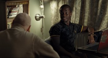 Movie still from “I, Daniel Blake” (2016), directed by Ken Loach – A man sitting in front of another man in a room; Medium shot, Over the shoulder angle