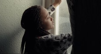 Movie still from “I, Daniel Blake” (2016), directed by Ken Loach – A little girl looking out of a window; Close Up shot, Low angle