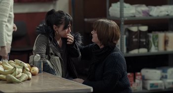 Movie still from “I, Daniel Blake” (2016), directed by Ken Loach – Two women sitting at a table talking to each other; Medium shot, Over the shoulder angle