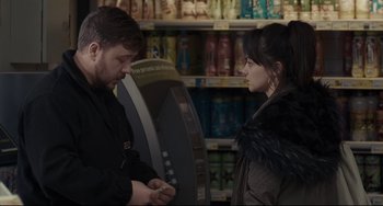 Movie still from “I, Daniel Blake” (2016), directed by Ken Loach – A man and a woman are talking in front of a vending machine; Medium shot, Over the shoulder angle
