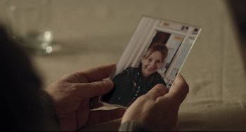 Movie still from “I, Daniel Blake” (2016), directed by Ken Loach – A person holding a picture of a woman; Extreme Close Up shot, Over the shoulder angle