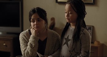 Movie still from “I, Daniel Blake” (2016), directed by Ken Loach – Two young women are looking at a piece of paper; Close Up shot, Over the shoulder angle