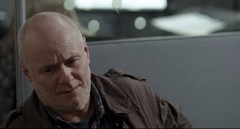 Movie still from “I, Daniel Blake” (2016), directed by Ken Loach – An older man sitting on a couch with his eyes closed; Close Up shot, Over the shoulder angle