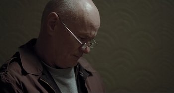 Movie still from “I, Daniel Blake” (2016), directed by Ken Loach – A bald man with glasses looking down at his face; Close Up shot, Low angle