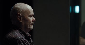 Movie still from “I, Daniel Blake” (2016), directed by Ken Loach – An older man with a shaved head looking to his left; Close Up shot, Over the shoulder angle