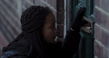 Movie still from “I, Daniel Blake” (2016), directed by Ken Loach – A young woman in a black jacket looking into a window; Close Up shot, Over the shoulder angle
