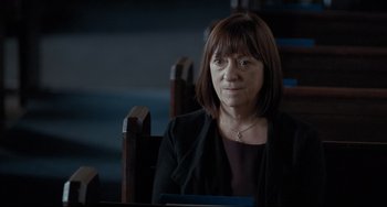 Movie still from “I, Daniel Blake” (2016), directed by Ken Loach – A woman sitting in a chair in front of a window; Close Up shot, Over the shoulder angle