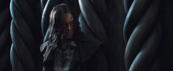 Movie still from “I, Frankenstein” (2014), directed by Stuart Beattie – The head and shoulders of a man wearing a long black coat; Close Up shot, Low angle