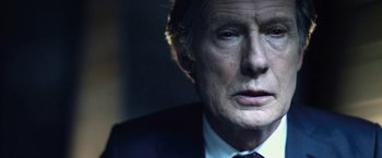 Movie still from “I, Frankenstein” (2014), directed by Stuart Beattie – An older man wearing a suit and tie; Close Up shot, Over the shoulder angle