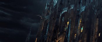 Movie still from “I, Frankenstein” (2014), directed by Stuart Beattie – A large building with a bird flying in the sky; Extreme Wide shot, Low angle