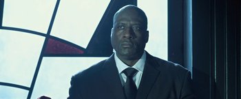 Movie still from “I, Frankenstein” (2014), directed by Stuart Beattie – A man wearing a suit and tie in front of a window; Close Up shot, Low angle