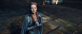 Movie still from “I, Frankenstein” (2014), directed by Stuart Beattie – A woman standing in front of a pillar wearing a blue cape; Medium shot, High angle