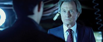 Movie still from “I, Frankenstein” (2014), directed by Stuart Beattie – A man wearing a suit and tie looking at himself in a mirror; Close Up shot, Over the shoulder angle