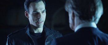 Movie still from “I, Frankenstein” (2014), directed by Stuart Beattie – A man wearing a leather jacket talking to another man; Close Up shot, Over the shoulder angle