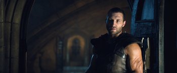 Movie still from “I, Frankenstein” (2014), directed by Stuart Beattie – A man in a leather jacket standing in a dark room; Medium shot, Low angle