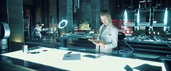 Movie still from “I, Frankenstein” (2014), directed by Stuart Beattie – A woman in a white lab coat holding a tablet; Medium shot, Low angle