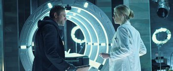 Movie still from “I, Frankenstein” (2014), directed by Stuart Beattie – A man and a woman are standing in front of a circular tunnel; Medium shot, Over the shoulder angle