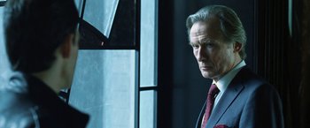 Movie still from “I, Frankenstein” (2014), directed by Stuart Beattie – A man in a suit and tie standing in front of a window; Close Up shot, Over the shoulder angle