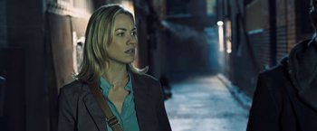 Movie still from “I, Frankenstein” (2014), directed by Stuart Beattie – A woman in a jacket and a blue shirt is walking down the street; Close Up shot, Over the shoulder angle